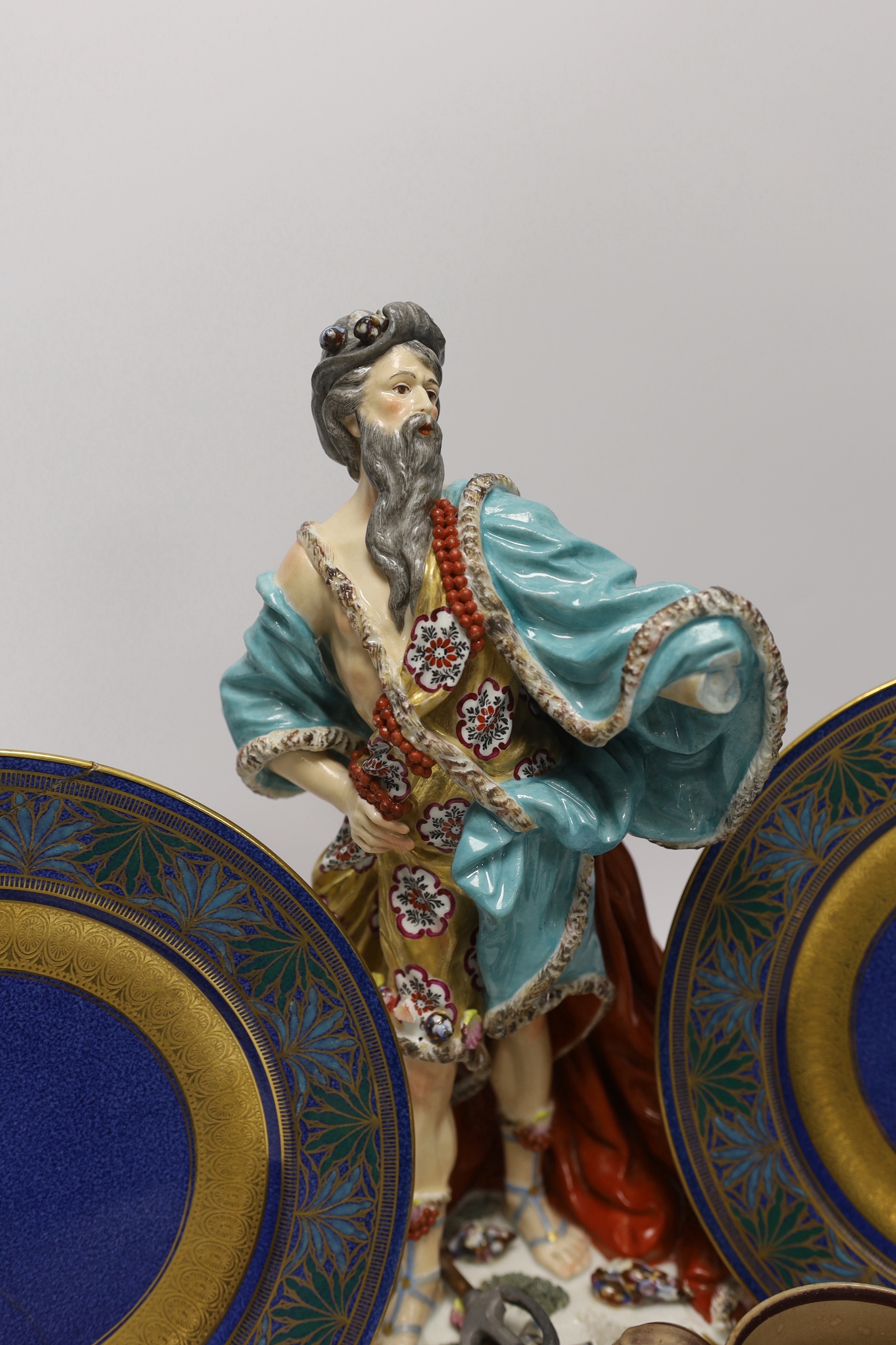 A Derby style figure of Neptune, two Wedgwood plates (one a.f.) and a Staffordshire drab ground jug, largest 32cm high